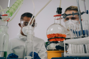 Male and female medical technicians working together in a laboratory with scientific equipment.