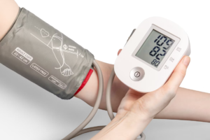 Close-up of an automatic upper-arm blood-pressure monitor on a patient’s arm