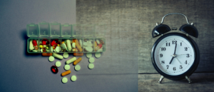 “Alarm clock and medication pills”