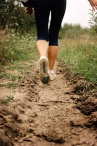 âPerson walking on a forest path for exercise and wellness.â