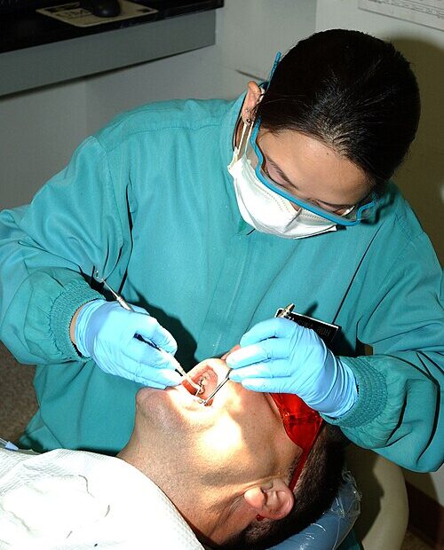“Dental hygienist performing a routine cleaning in a modern dental clinic”