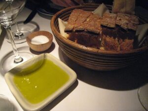 Artisan bread with extra-virgin olive oil and salt illustrating healthy unsaturated fats