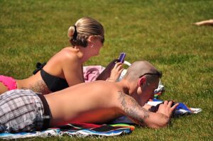 couple outdoors enjoying safe sunlight exposure